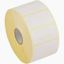 A roll of white thermal labels on a yellow core, typically used for labeling in a office or retail setting.